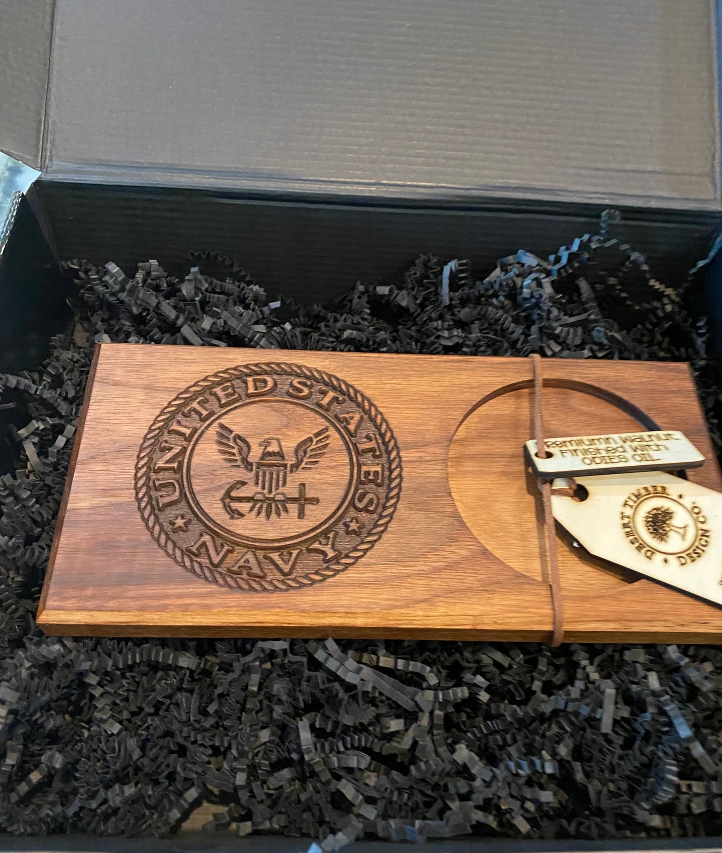 Wooden plaque with engraved 'United States Navy' logo in a box.
