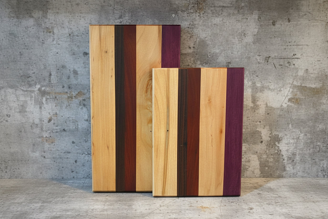 Two wooden cutting boards with purple and red stripes on a marble surface.