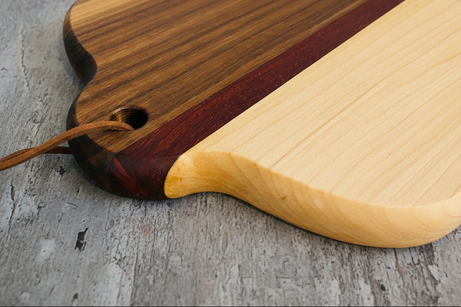 Two wooden cutting boards with a visible joint on a gray surface