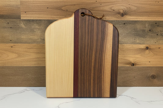 Wooden cutting board with a unique grain pattern against a wooden background