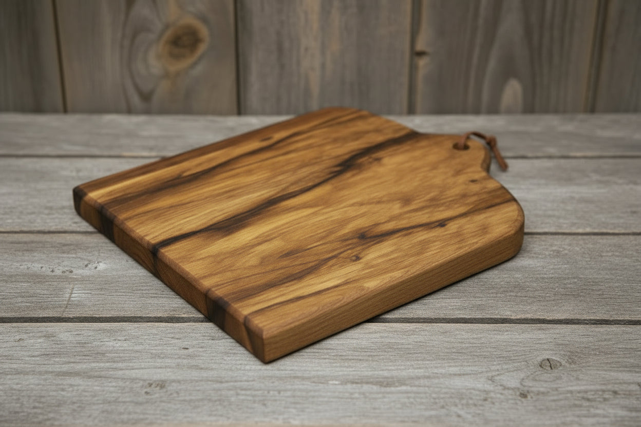 Wooden cutting board with a handle on a wooden surface