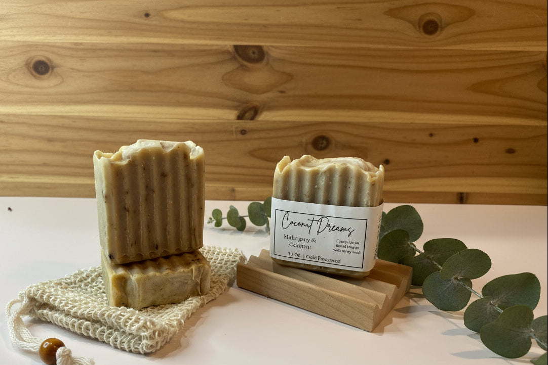 Two bars of soap on a wooden stand with a wooden background