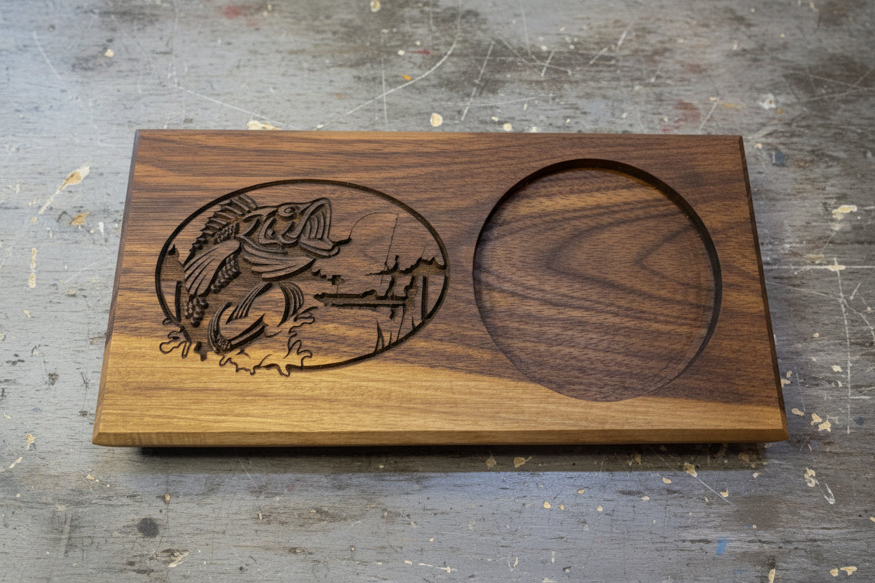 Wooden tray with fish design and circular cutout on a grey background