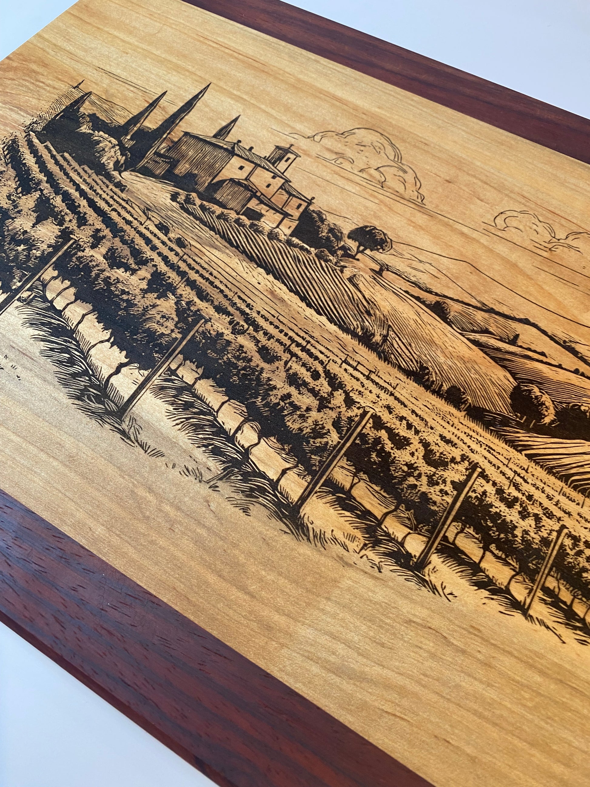 Wooden cutting board with an engraved vineyard design