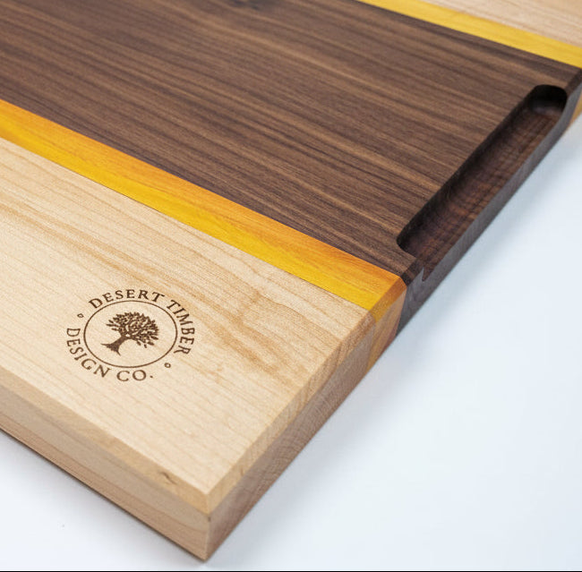 Maple, Yellow Heart, Walnut Cutting board backside show casing the finger gribs. 