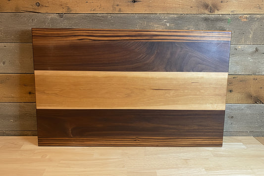 Wooden cutting board with striped pattern on a neutral background