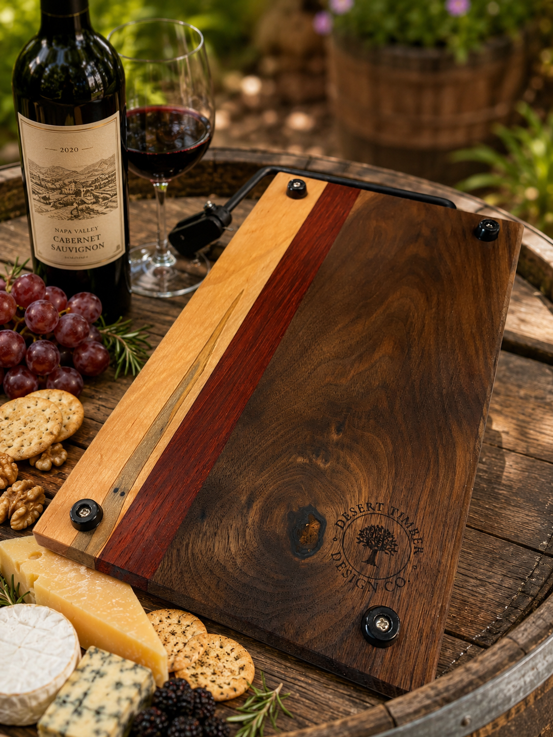 Wooden cutting board with a wine bottle, glass, and snacks on a barrel