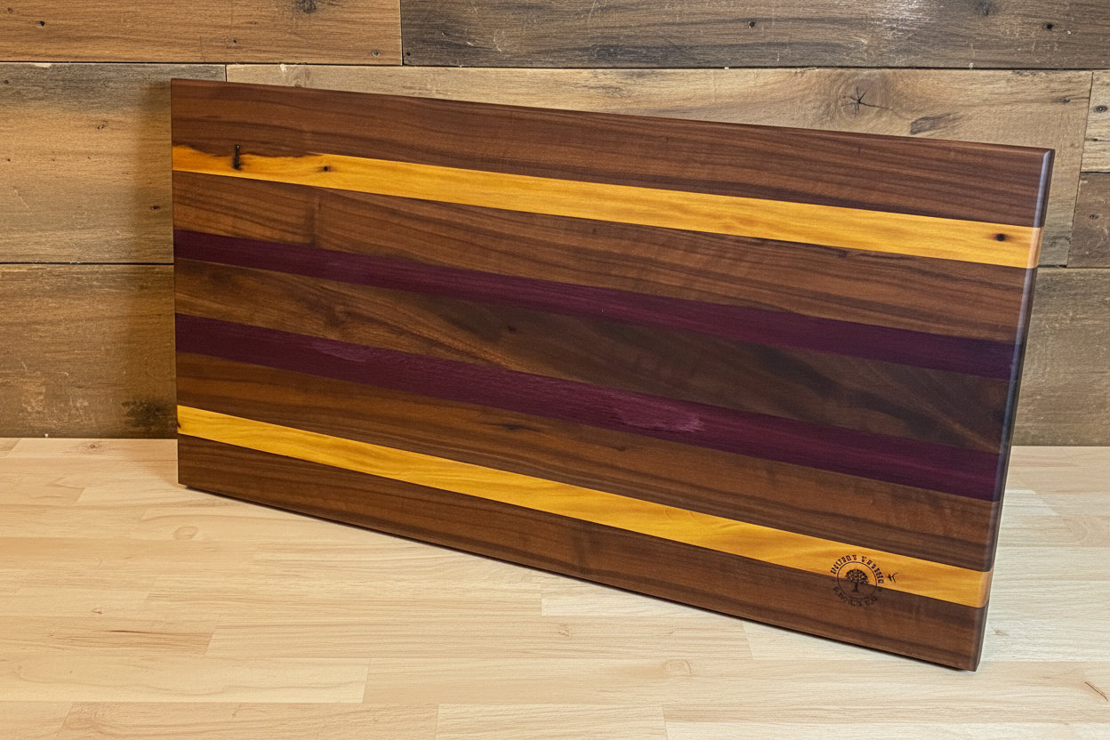 Wooden cutting board with purple and yellow stripes on a wooden floor.